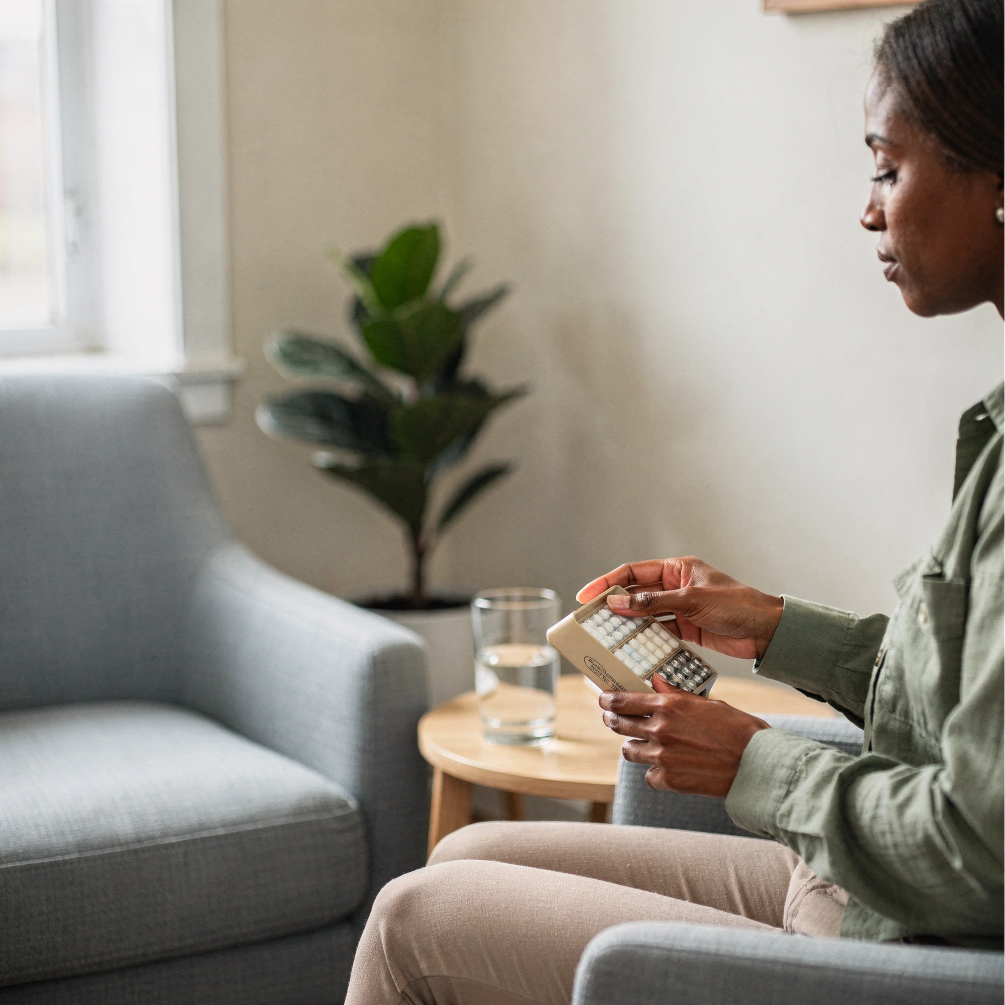 Patient holding a weekly pill organizer – medication management in Norristown, PA